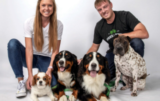 Owners of paws and pints, Kyle and Megan, pose with their four dogs